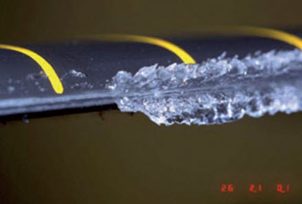 Ice formation on an untreated airplane wing in wind tunnel test.